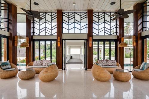 a lobby with couches and chairs in a building at The Kayana Beach Lombok in Senggigi 