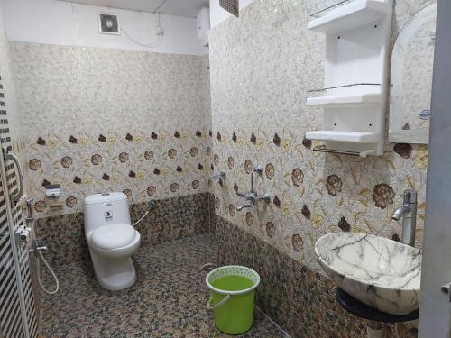 a dirty bathroom with a toilet and a sink at Andaman Runway in Port Blair