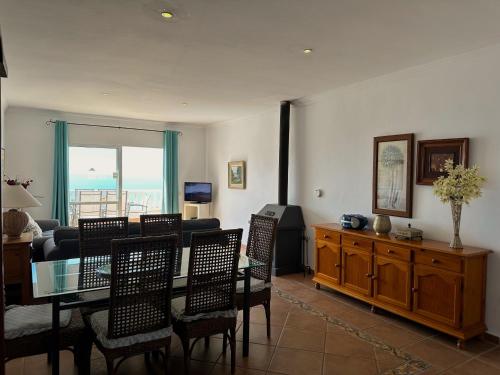 a living room with a table and chairs and a couch at Nerja Paradise Rentals - Villa Dos Ardillas in Nerja