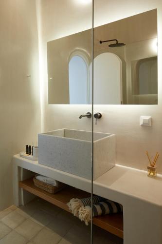 a bathroom with a sink and a mirror at Thiro Exclusive Villa with private jacuzzi in Pirgos