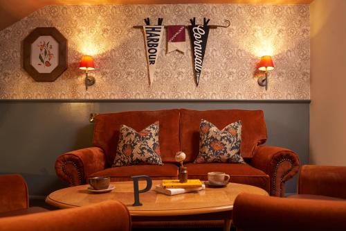 a living room with a couch and a table at Harbour Inn in Porthleven
