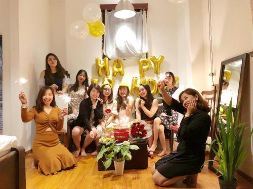 a group of women posing in a room with balloons at City Hostel Da Nang in Danang