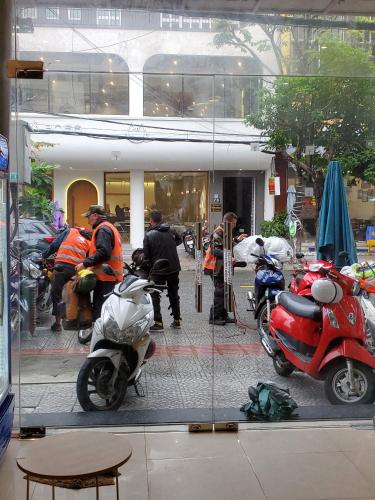 a group of motorcycles parked in front of a building at City Hostel Da Nang in Da Nang