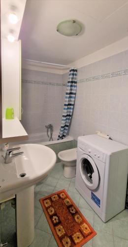 a bathroom with a washing machine and a sink at Bicycle road in Imperia