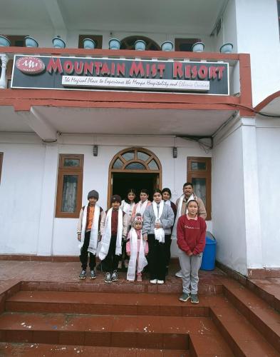 a group of people standing in front of a building at Mountain Mist in Tawang