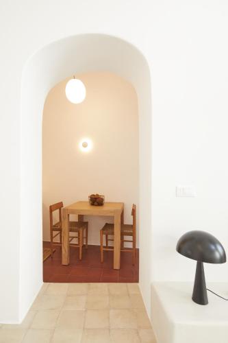 a dining room with a table and chairs at Thiro Exclusive Villa with private jacuzzi in Pirgos