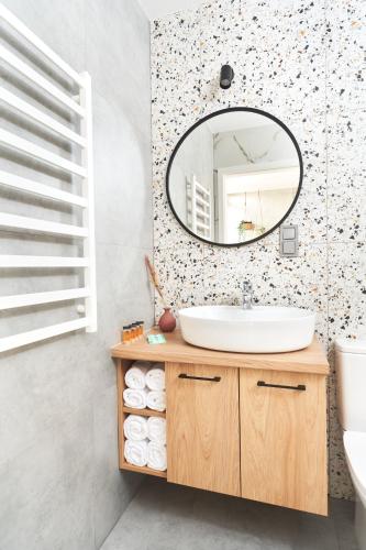 a bathroom with a sink and a mirror at Na Fursie Apartments & Rooms in Nowy Targ