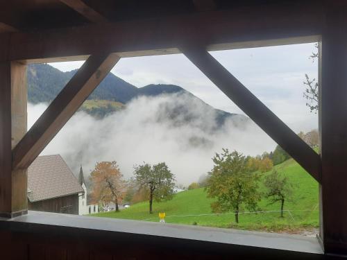a window with a view of a foggy mountain at Sunnaschi Appartements - Wohnungen oder gesamt als "Hütte" in Laterns