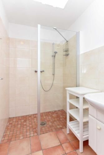 a bathroom with a shower and a sink at Ferienhaeuser Strandburgen in Bensersiel