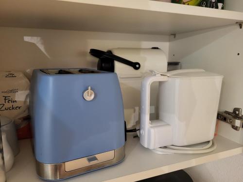a coffee maker and a toaster on a shelf at Sunnaschi Appartements - Wohnungen oder gesamt als "Hütte" in Laterns