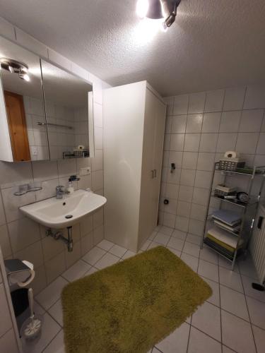 a bathroom with a sink and a mirror at Sunnaschi Appartements - Wohnungen oder gesamt als "Hütte" in Laterns
