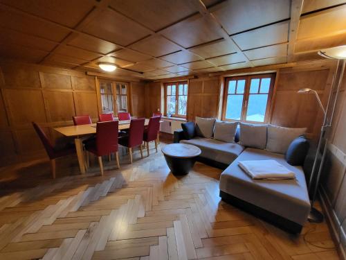 a living room with a couch and a table at Sunnaschi Appartements - Wohnungen oder gesamt als "Hütte" in Laterns