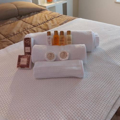 a bed with towels and other items on it at AURUM Affittacamere in Loreto