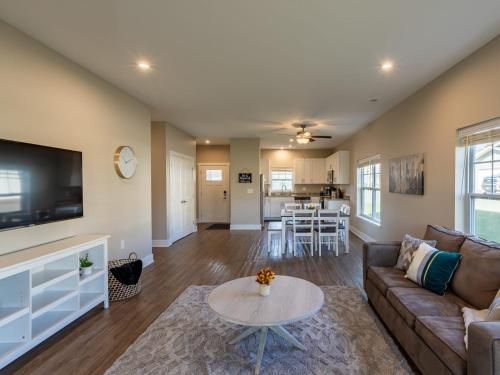 a living room with a couch and a table at Modern 2BR 2BA New Build Condo with Garage & Patio in Wyoming
