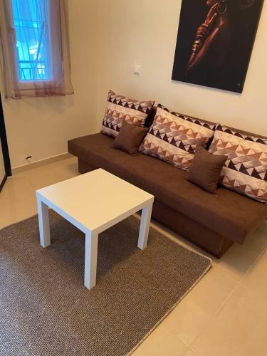 a living room with a couch with a coffee table at Ifos Apartments in Thessaloniki