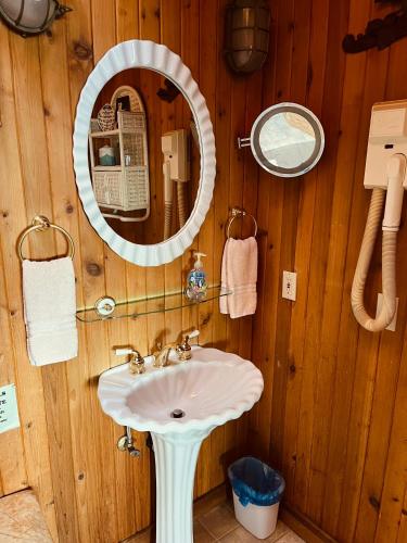a bathroom with a sink and a mirror at Sanctuary Seaside in Eastsound