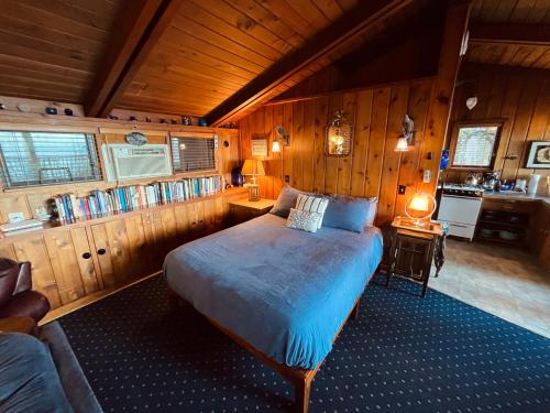 a bedroom with a bed in a room with wooden walls at Sanctuary Seaside in Eastsound