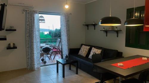a living room with a couch and a table at Katarina Apartments Kefalonia - Sea View in Kefallonia