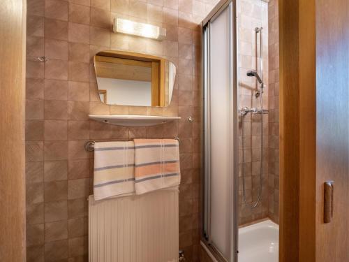 a bathroom with a shower and a sink and a mirror at Im Riederhof in Going am Wilden Kaiser