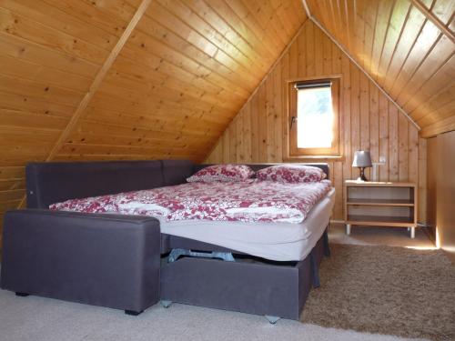 1 dormitorio con 1 cama en una habitación de madera en DOMKI CZYRNA SZCZYRK, en Szczyrk