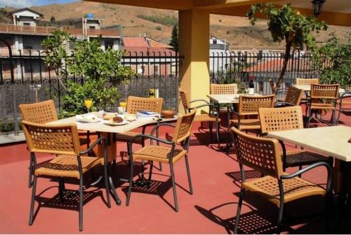 a restaurant with tables and chairs on a patio at Hotel Scrivano in Randazzo