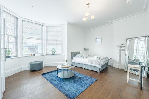 a living room with a bed and a table at The Royal Bell Apartments - Central Bromley in Bromley