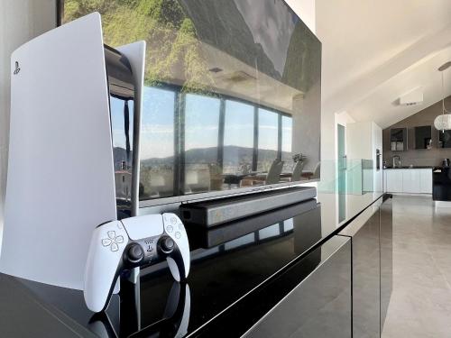 a living room with a video game controller in a house at Luxury Laurus Penthouse with awesome sea view in Primošten