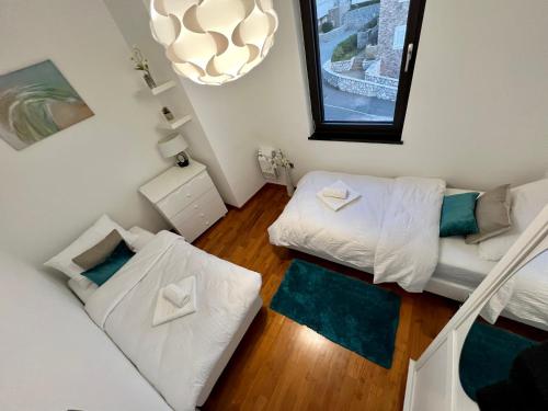 a small room with two beds and a couch at Luxury Laurus Penthouse with awesome sea view in Primošten