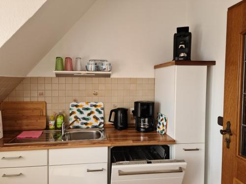 a kitchen with a sink and a counter top at Ferienwohnung Haus Fischer in Langwedel