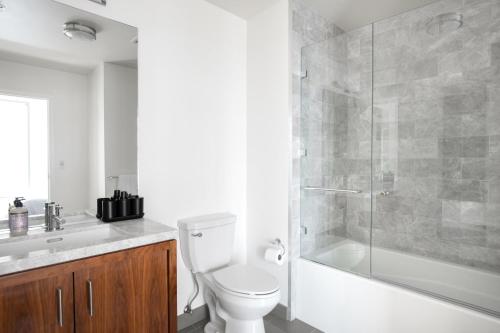 a bathroom with a toilet and a glass shower at Downtown Studio w Gym Pool nr Metro Center LAX-279 in Los Angeles