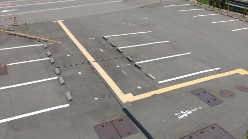 an empty parking lot with a street with a street at Hotel Hakusan Hills in Hakusan