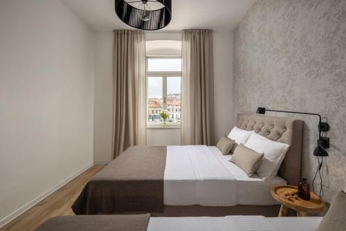 a bedroom with a large bed and a window at Apartment Centro Pola in Pula