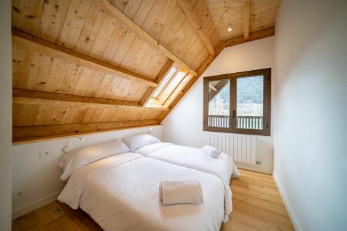 a bedroom with two beds and a window at Aran Hostel in Salardú