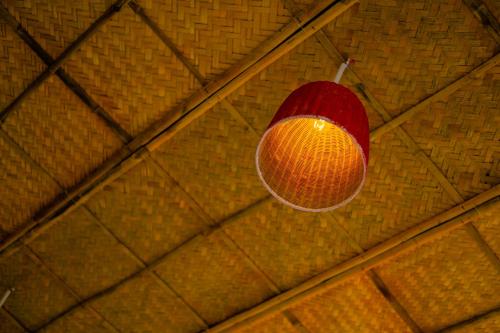 a red light hanging from a ceiling at 5 Coconut Villa in Hoi An