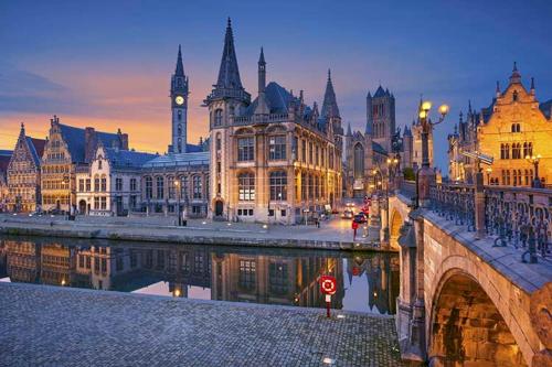 a city with a bridge and buildings and a clock tower at Phoenix in Ghent