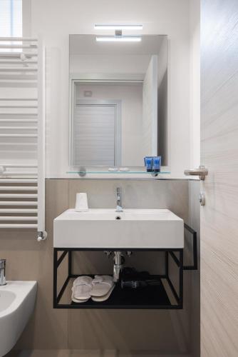 a bathroom with a sink and a mirror at Seaside Hotel in Capo dʼOrlando