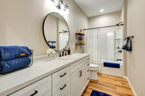 a bathroom with a sink and a mirror at Chic Wisconsin Retreat with Deck, Grill and Fire Pit! in Wisconsin Dells