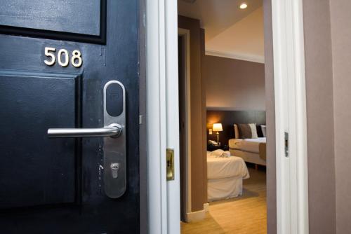 a door to a room with a bedroom and a bed at 1253 Recoleta Small Hotel in Buenos Aires