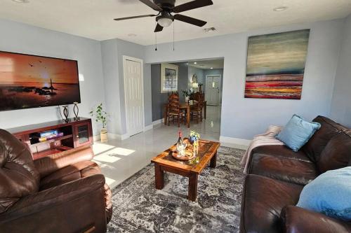a living room with a couch and a table at Paradise Vacation Home in Boynton Beach