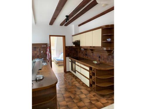 uma cozinha com armários de madeira e piso em azulejo em Ferienwohnung Am Schloss em Sigmaringen