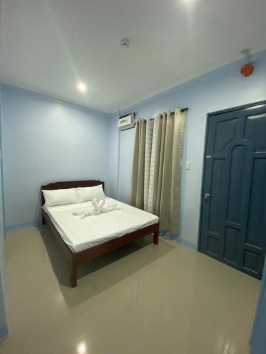 Ένα ή περισσότερα κρεβάτια σε δωμάτιο στο Althea Apartelle