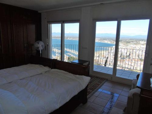 Schlafzimmer mit einem Bett und Meerblick in der Unterkunft Villa avec piscine et vue panoramique mer in Roses
