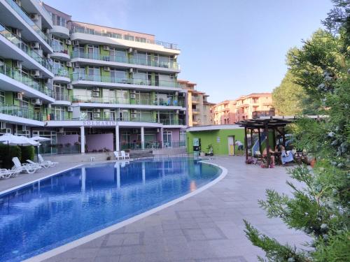 a swimming pool in front of a building at Sunny Beach Studio in Apartcomplex Solmarine in Sunny Beach