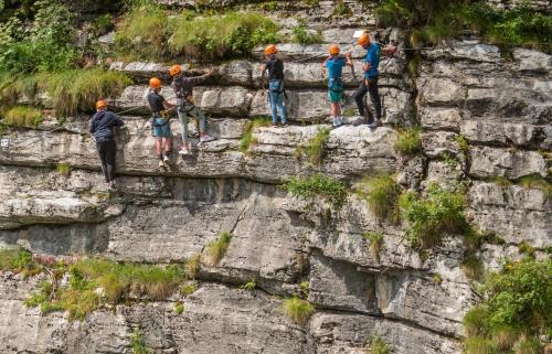a group of people standing on a rock wall at Hôtel Club MMV Le Flaine in Flaine