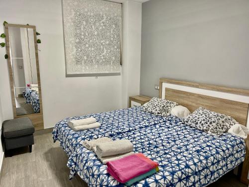 um quarto com uma cama com um edredão azul e branco em Don Paco Modern Loft em Marbella