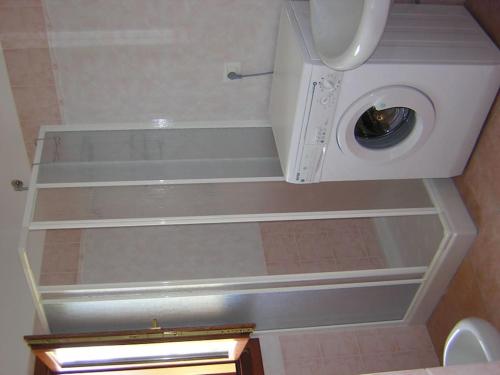 a bathroom with a washing machine in a room at Casa Santoreggia Olbia, Porto Istana, Murta Maria in Murta Maria