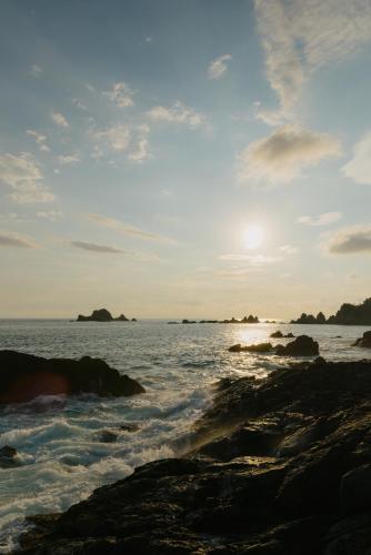 a view of the ocean with rocks in the water at Casa ALOA Ixtapa in Ixtapa