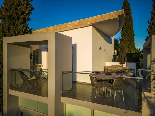 a balcony of a house with a table and chairs at Quinta de Santa Margarida - Charm Country House in Tavira