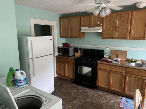 a kitchen with a white refrigerator and a stove at Historic Beach Side Getaway - Pet friendly, WiFi cottage in Norfolk