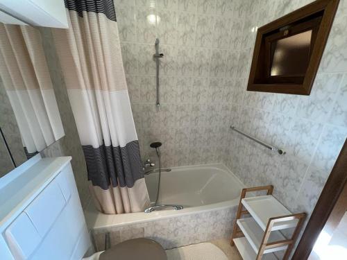 a bathroom with a bath tub and a shower at Huize Liesanne in Bredene
